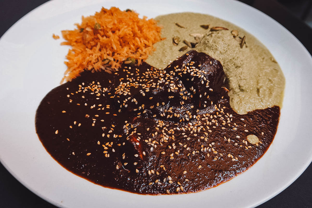 Mole poblano with pipian verde and red rice